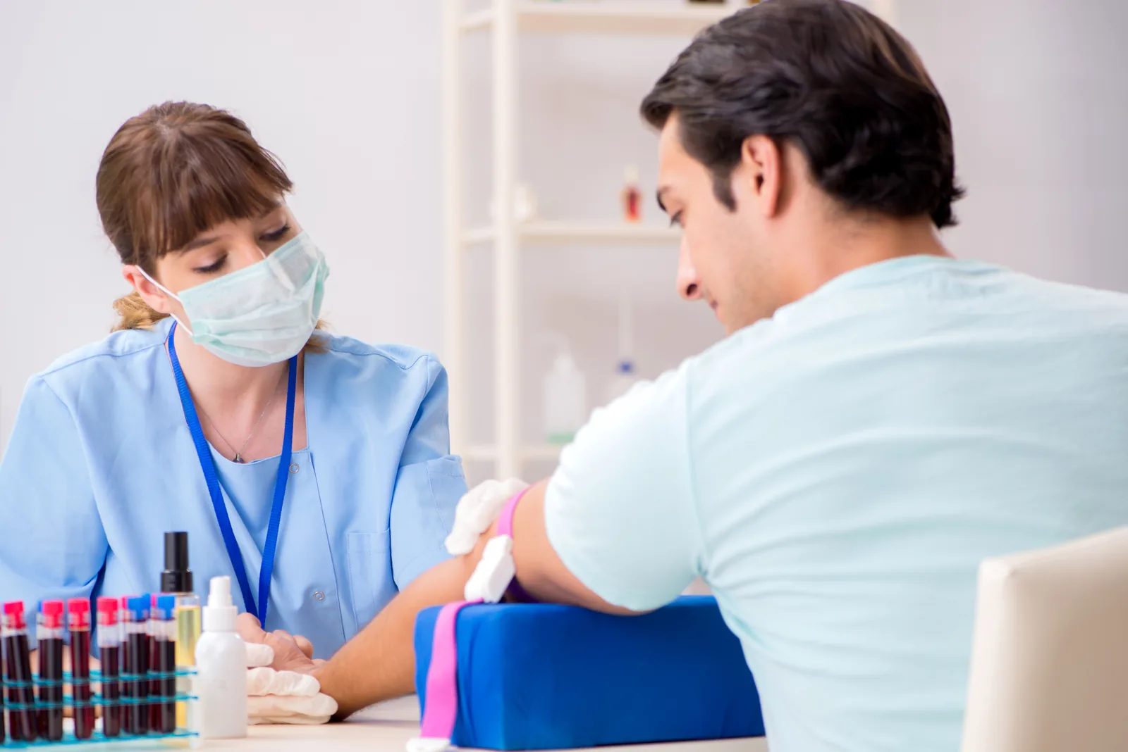 Bloodwork being drawn in a clinical setting