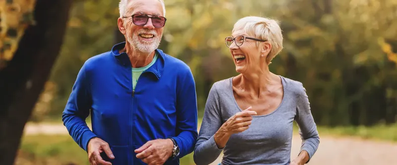 Active older couple jogging outdoors