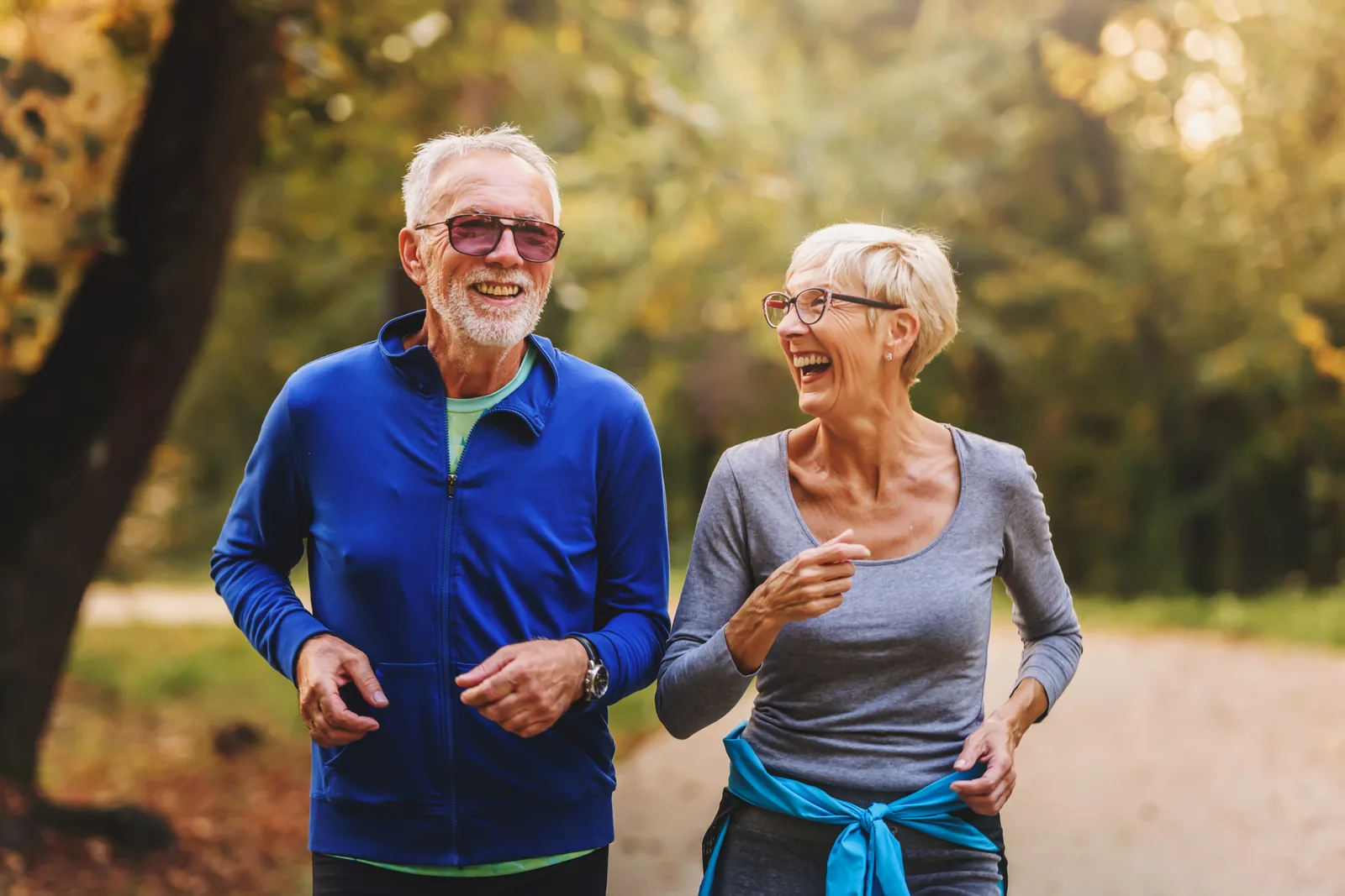 Active older couple jogging outdoors