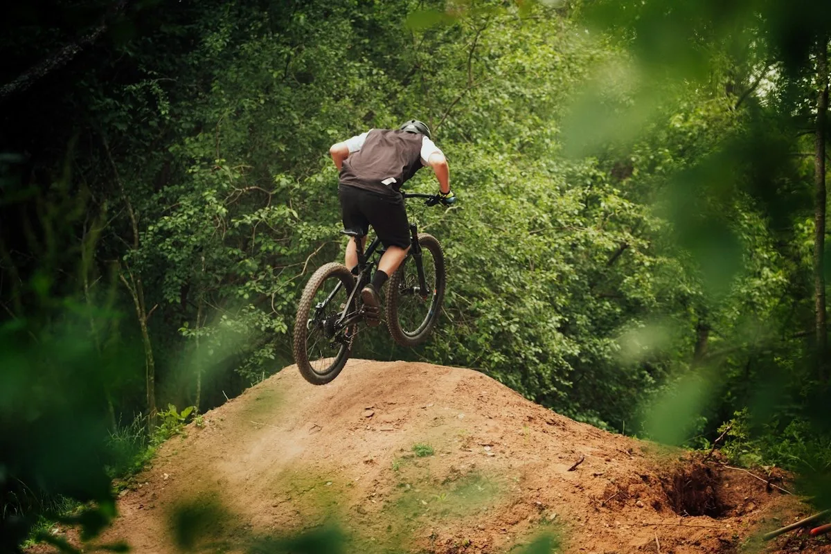 Man mountain biking on a forest trail