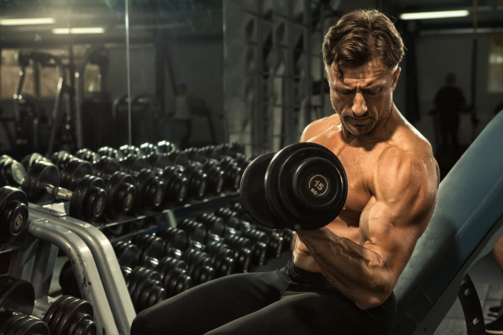 Man strength training with dumbbells